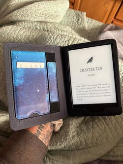 reviewer with the front flap flipped open showing the pockets on the left side and the reader display on the right