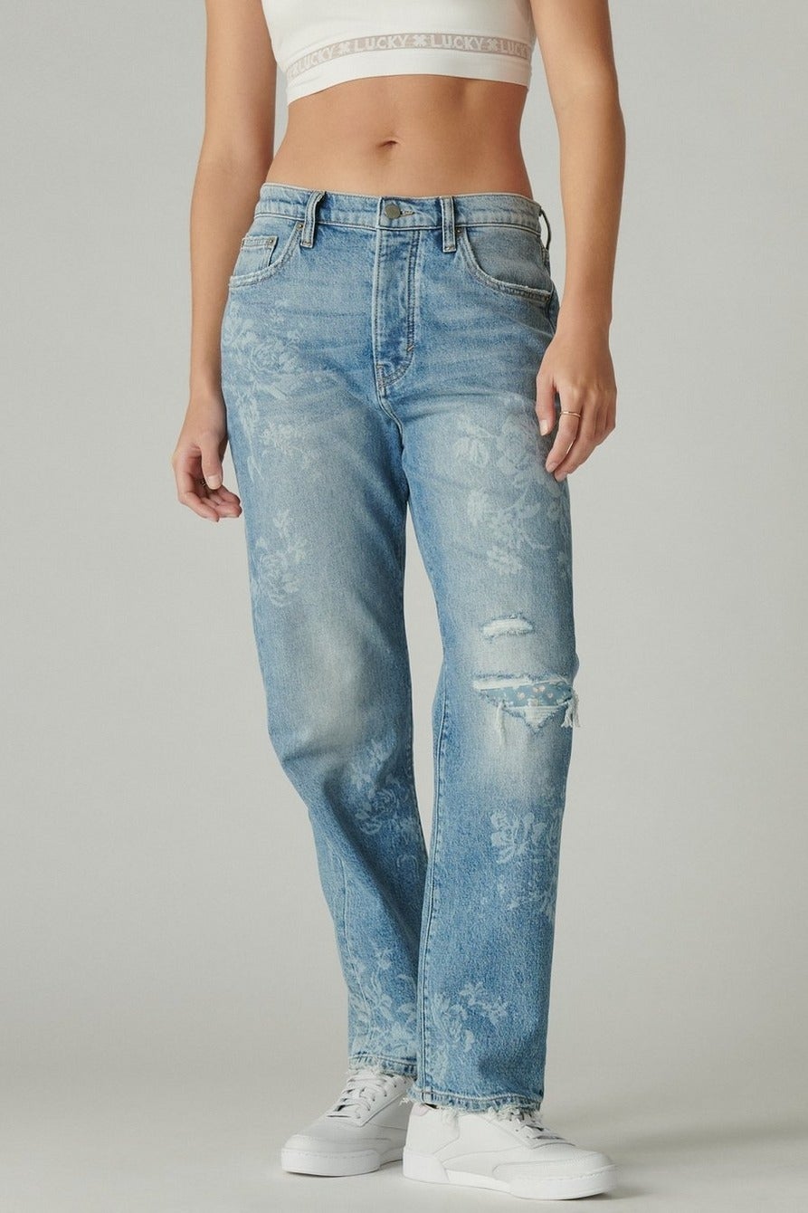 model wearing the blue jeans with subtle white flowers all over