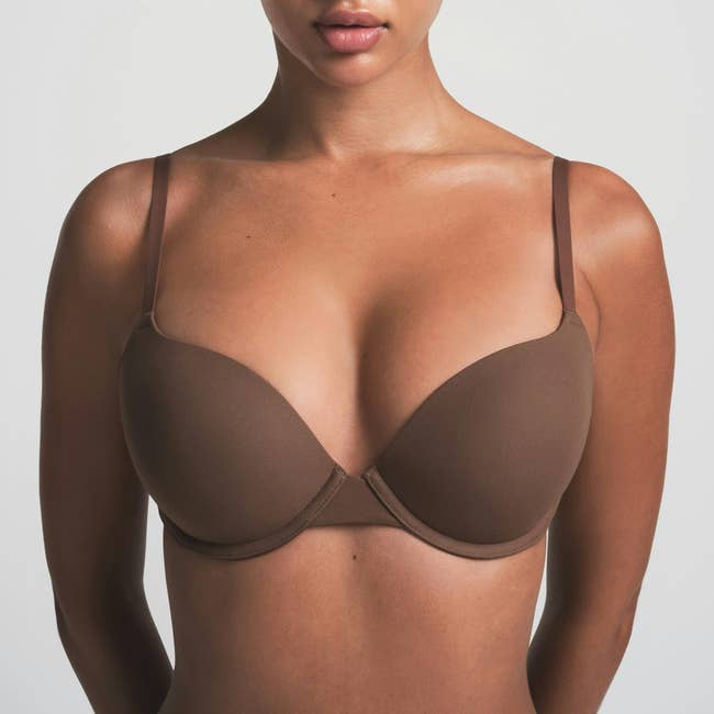 Person wearing a seamless, supportive bra, shown arsenic  portion  of a buying  nonfiction  connected  comfy  lingerie options