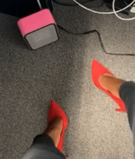 gif of reviewer's feet near a small pink space heater under their desk