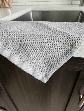 The waffle knit dish cloth spread out on a counter 