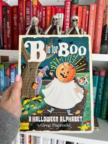 an editor holding a b is for boo picture book