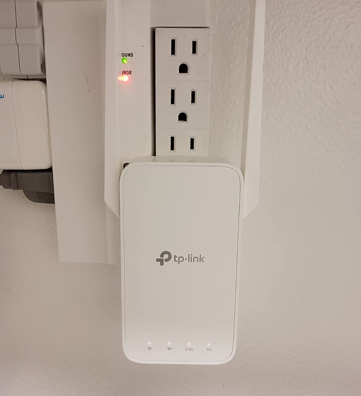 reviewer photo of the wifi extender plugged into an outlet