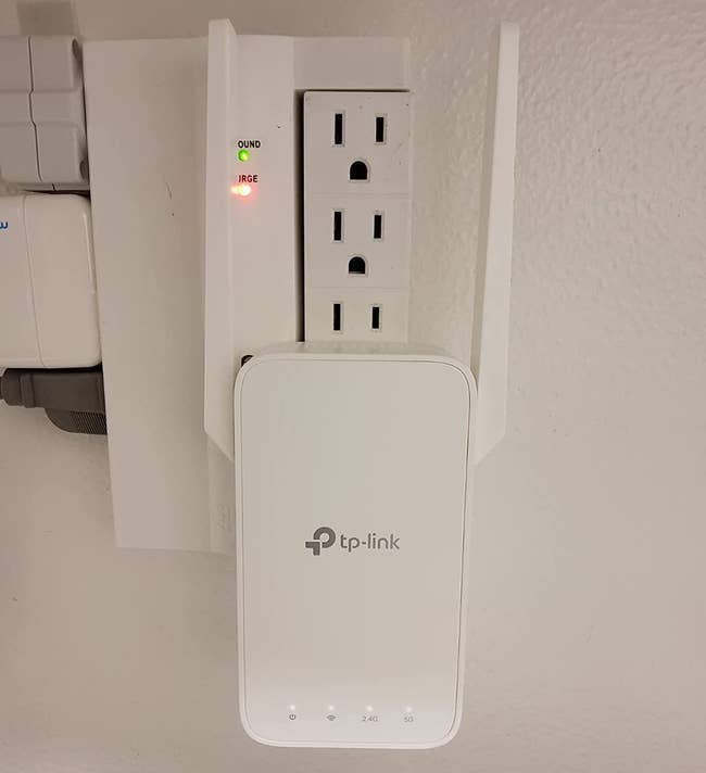 reviewer photo of the wifi extender plugged into an outlet