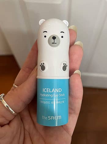 Reviewer holding the small polar bear-shaped eye stick