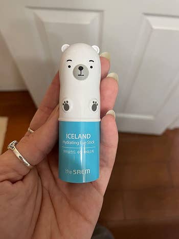 Reviewer holding the small polar bear-shaped eye stick