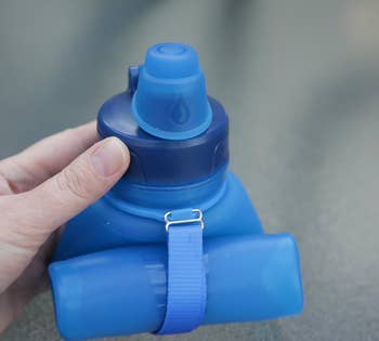 a reviewer's blue water bottle completely collapsed