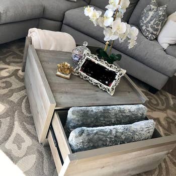 reviewer photo of coffee table with drawers full of blankets