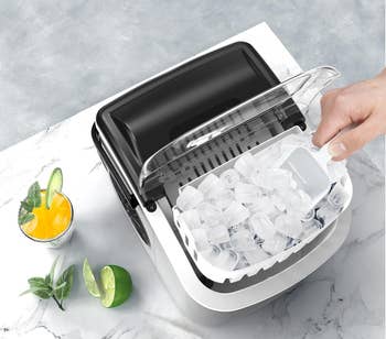 hand scooping ice from maker