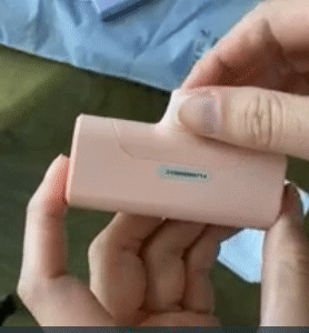 gif of reviewer holding the pink charger and showing its built-in lightning cable