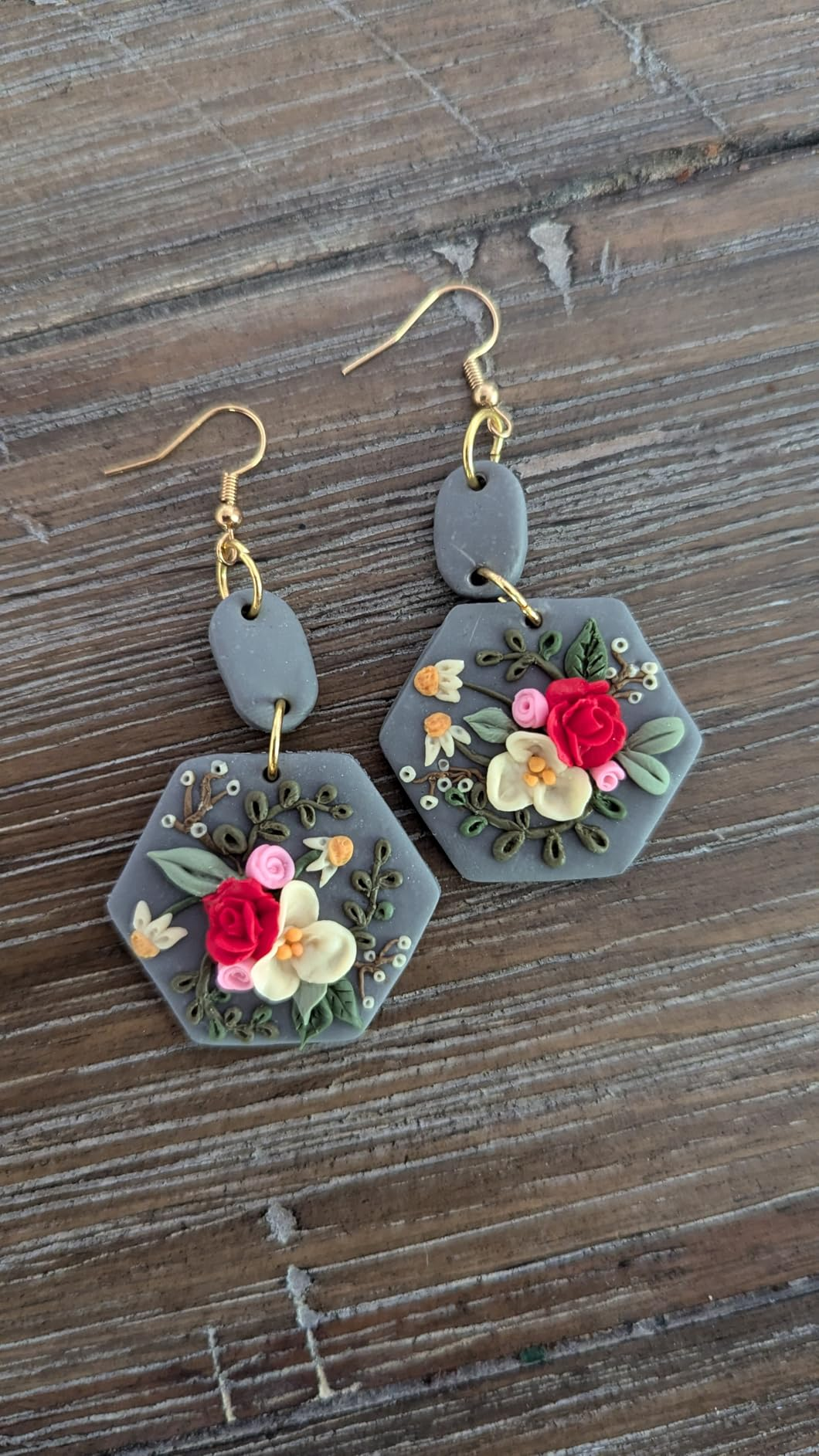 Hexagon earrings with intricate floral plan  featuring roses and delicate details
