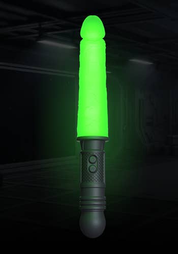 Glowing greenish  lightsaber-style artifact  with activation buttons connected  a sci-fi themed background