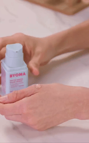 Person applying Byoma look   serum connected  tegument  with hands
