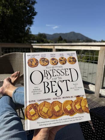 Reviewer holding book titled 