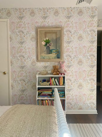 a various reviewer's room with  light crimson damask wallpaper