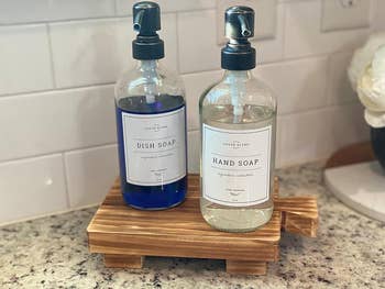 a reviewer’s hand and dish soap on a pedestal