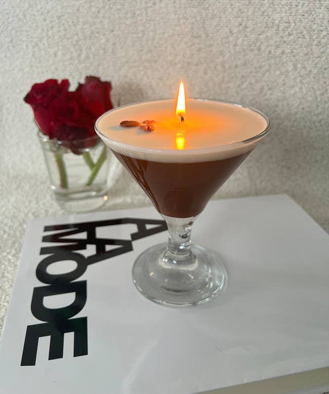 lit candle in a cocktail glass with a coffee aroma, accented with coffee beans