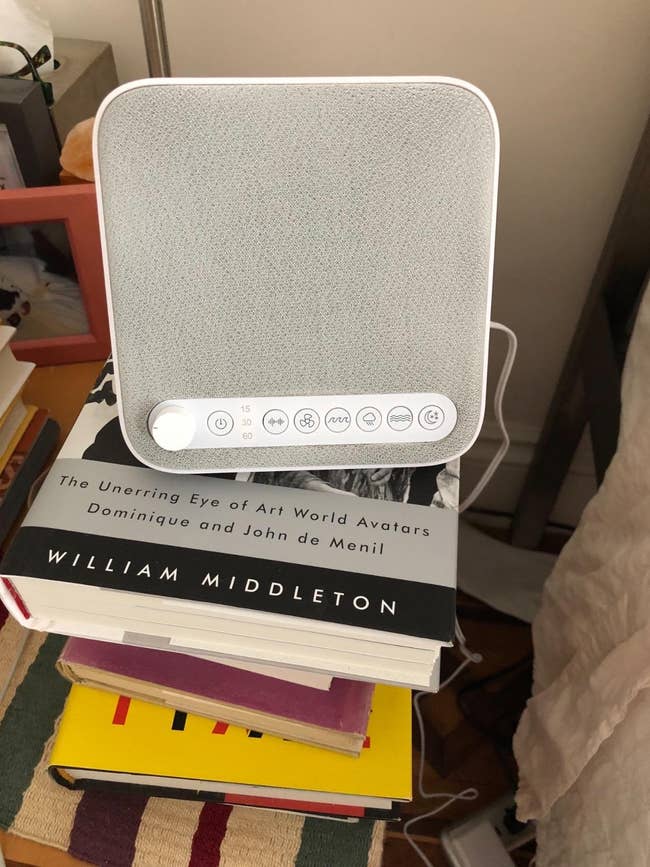 White sound instrumentality connected a stack of books, including