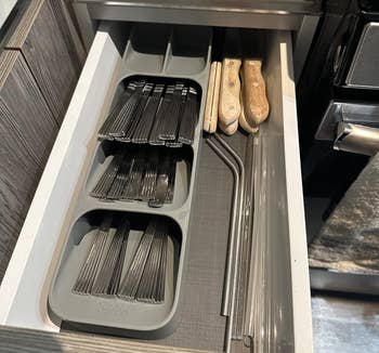 reviewer image of utensils stacked in the holder in a drawer