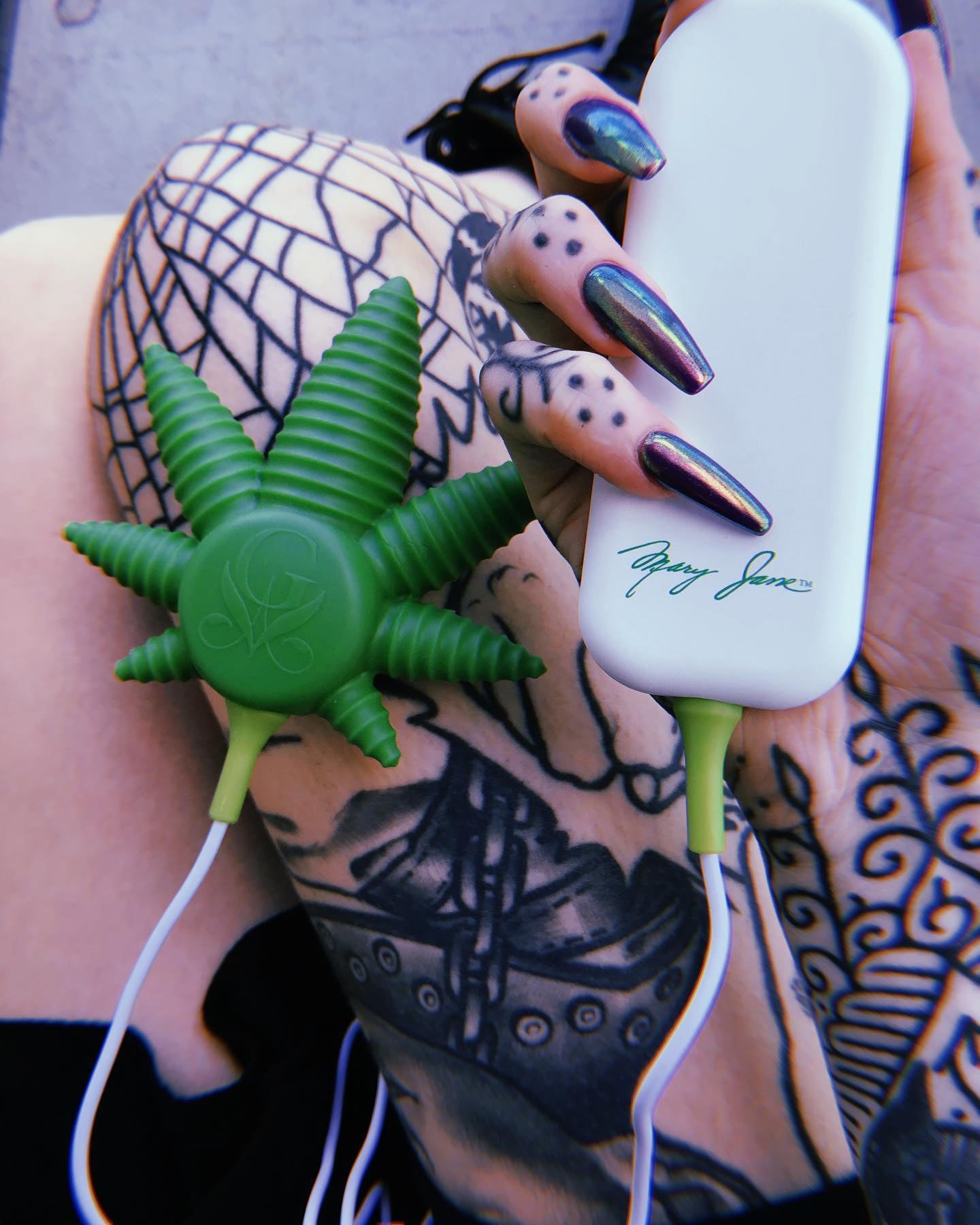 Model holding green leaf-shaped vibrator and white remote