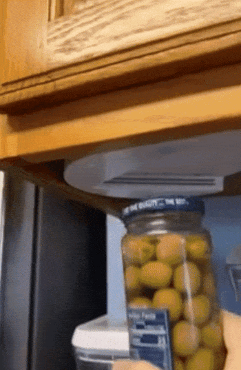 gif of a reviewer showing how easy it is to open a jar of olives only using one hand