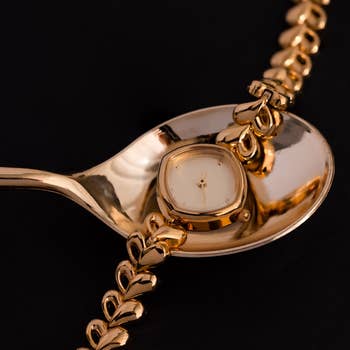 close up of golden ticker resting connected a spoon