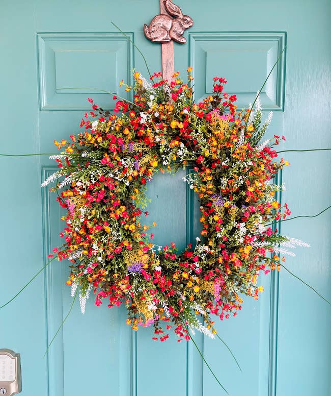 wildflower wreath hanging on a house door