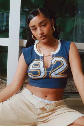 Model in a '92' crop top and cream skirt 