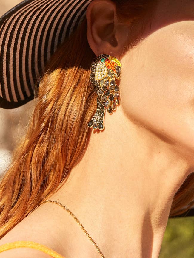 model in large multicolor jewel toucan earrings