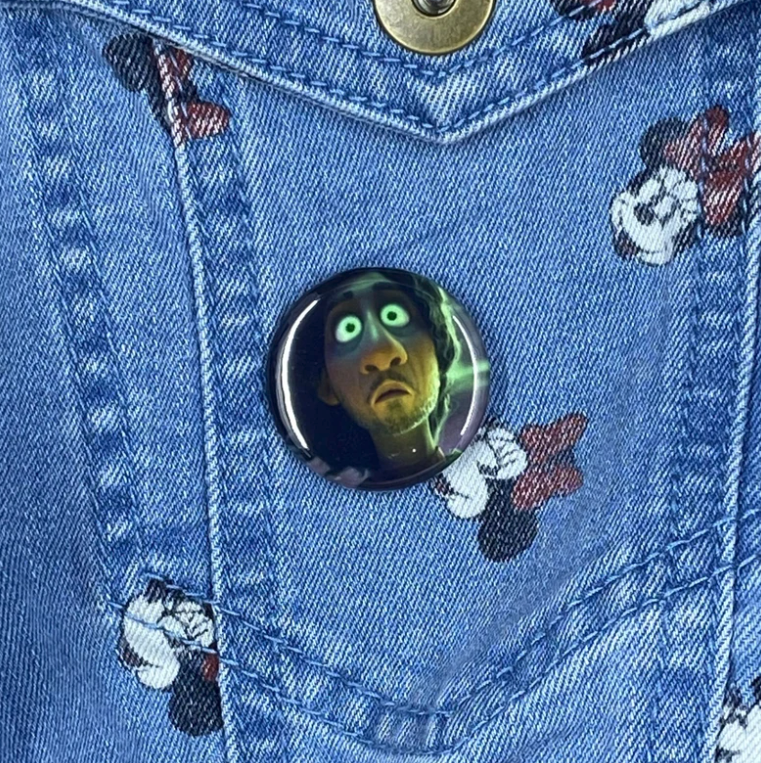 a photo of bruno seeing a vision on a button pin