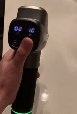 gif of a reviewer showing the massage gun 