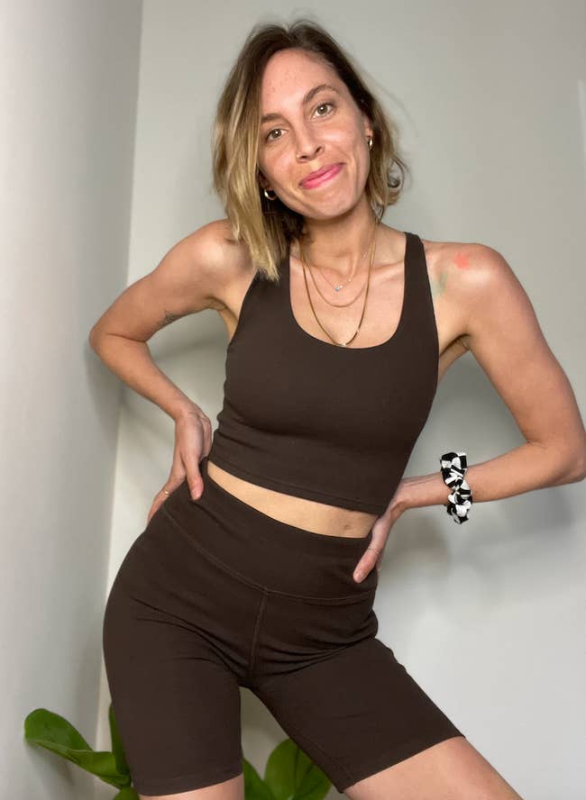 BuzzFeed editor Lara Parker wears matching brown sports bra top and bike shorts