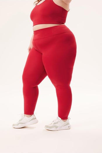 model wearing the full-length leggings in red