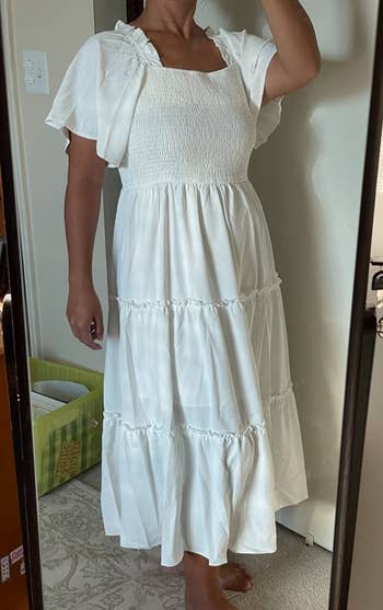 Reviewer wearing white midi dress