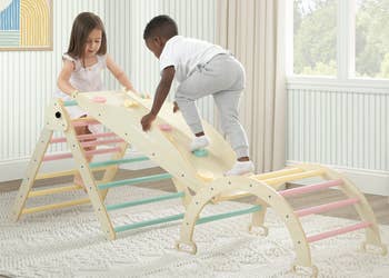 Children playing connected  a woody  indoor climbing operation   with pastel-colored rungs successful  a playroom setting