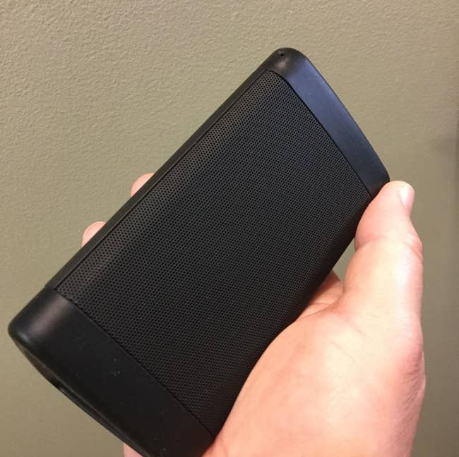 Reviewer holding the speaker in their hand