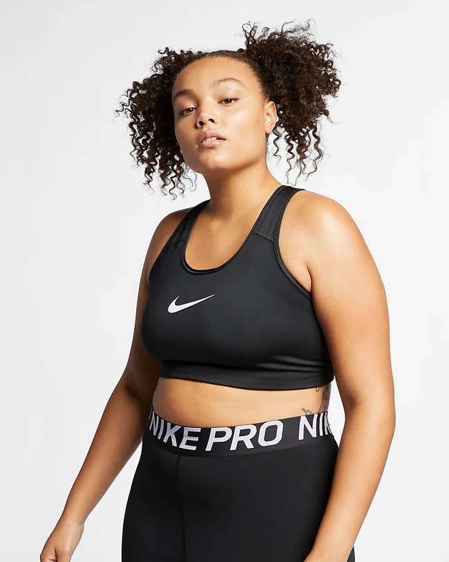 model wears black medium support sports bra