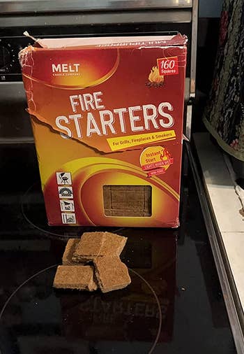 the box of fire starters and a couple of rectangles of it outside the box