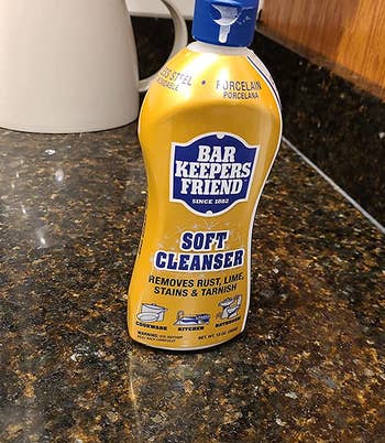 reviewer photo of the gold and blue bottle of bar keepers friend on a counter