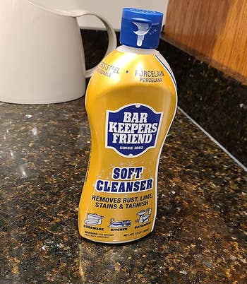reviewer photo of the gold and blue bottle of bar keepers friend on a counter