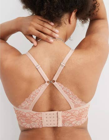 Model showcasing the back of a lace-detailed bra with adjustable straps and hook-and-eye closure