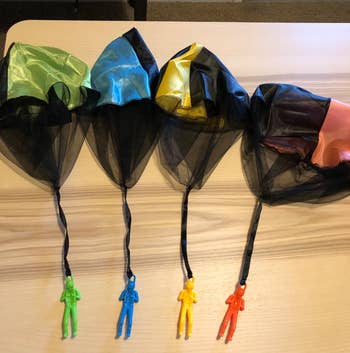 a reviewer photo of the four parachute toys 