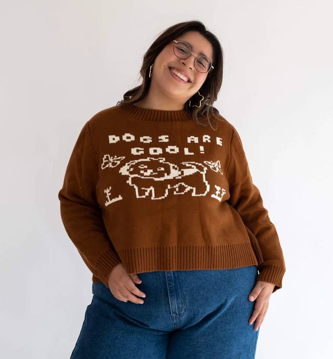 a model wearing the brown sweater that says 