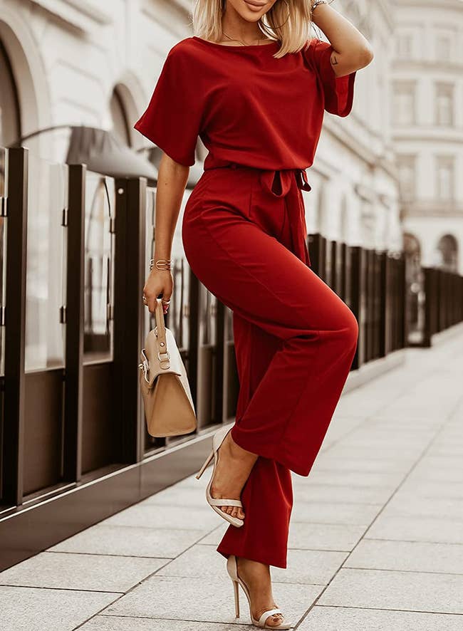 model wearing the short-sleeve red jumpsuit