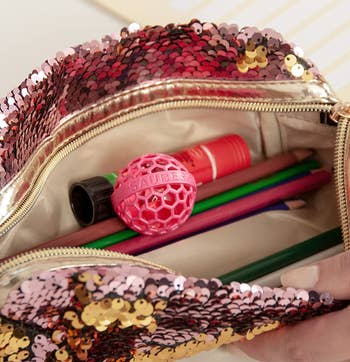 the pink cleaning ball in a purse