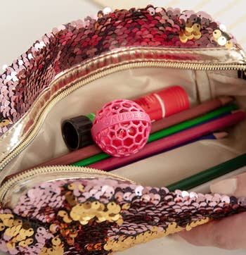 the pink cleaning ball in a purse