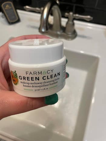 Reviewer holding Farmacy balm