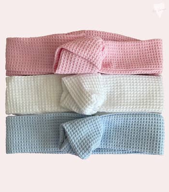 three waffle style headbands in pink, white, and grey