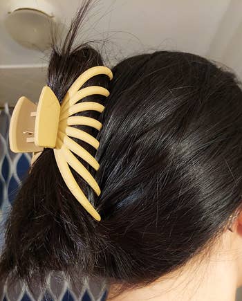 reviewer's hair secured with a large claw clip