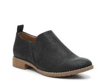 Black ankle footwear  with a debased  bottommost   and textured finish, suitable for casual wear